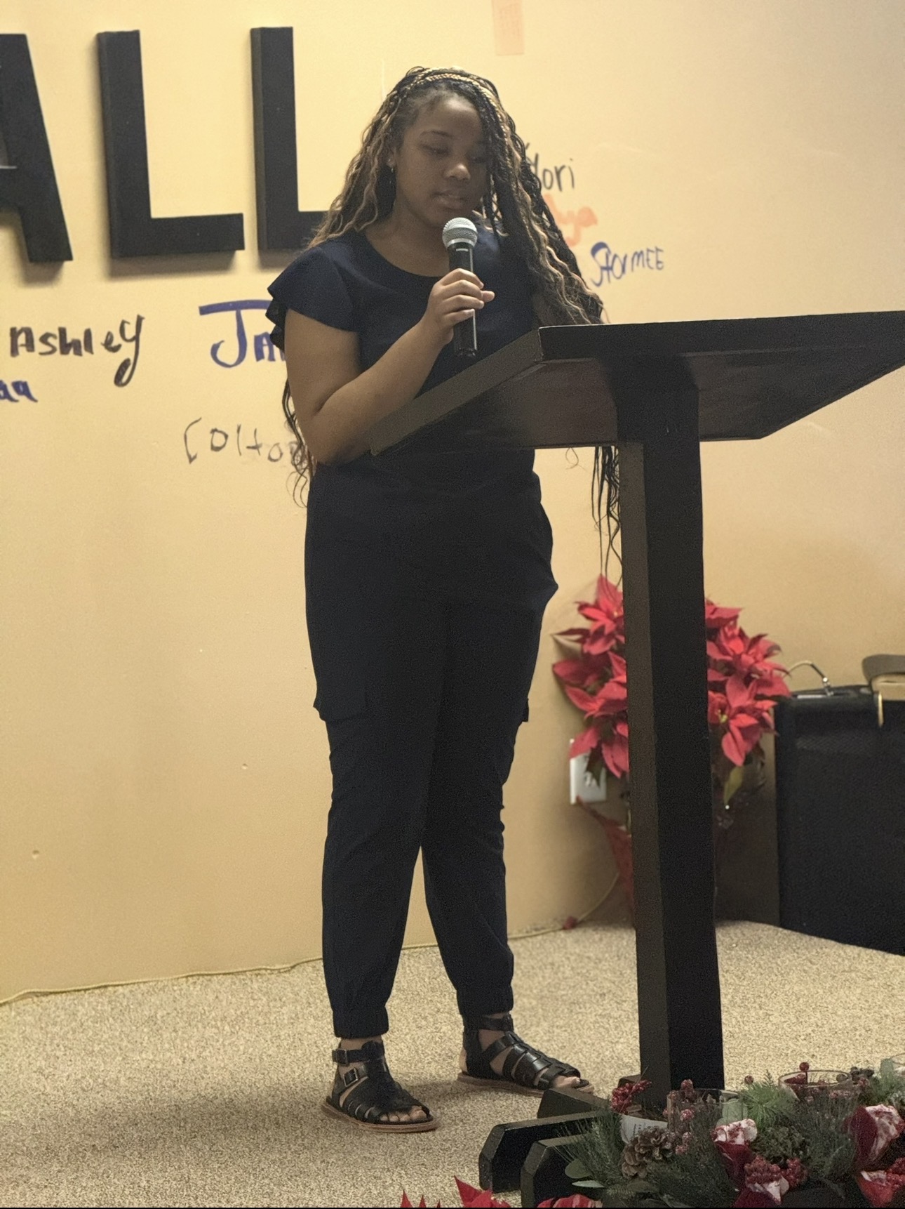 A young woman speaking from the church lectern