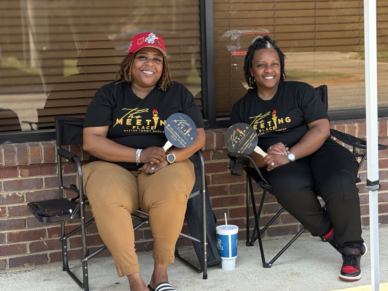 Two outreach volunteers welcoming the community