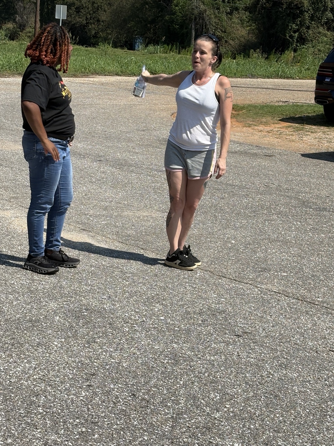 A ministry volunteer speaking with a community member during outreach