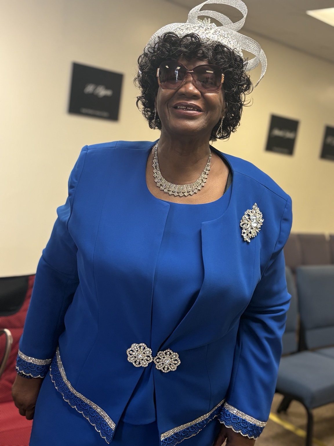 A woman in a blue suit smiling at church