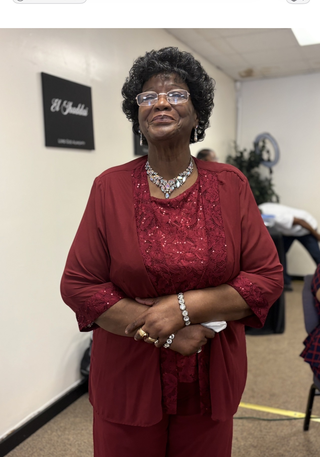 A beloved senior church member dressed in burgundy