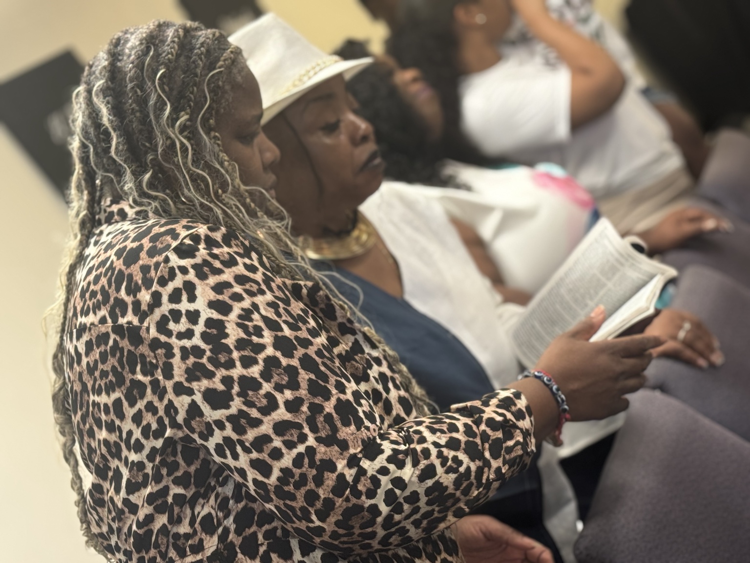 Women reading the Bible together during worship and study