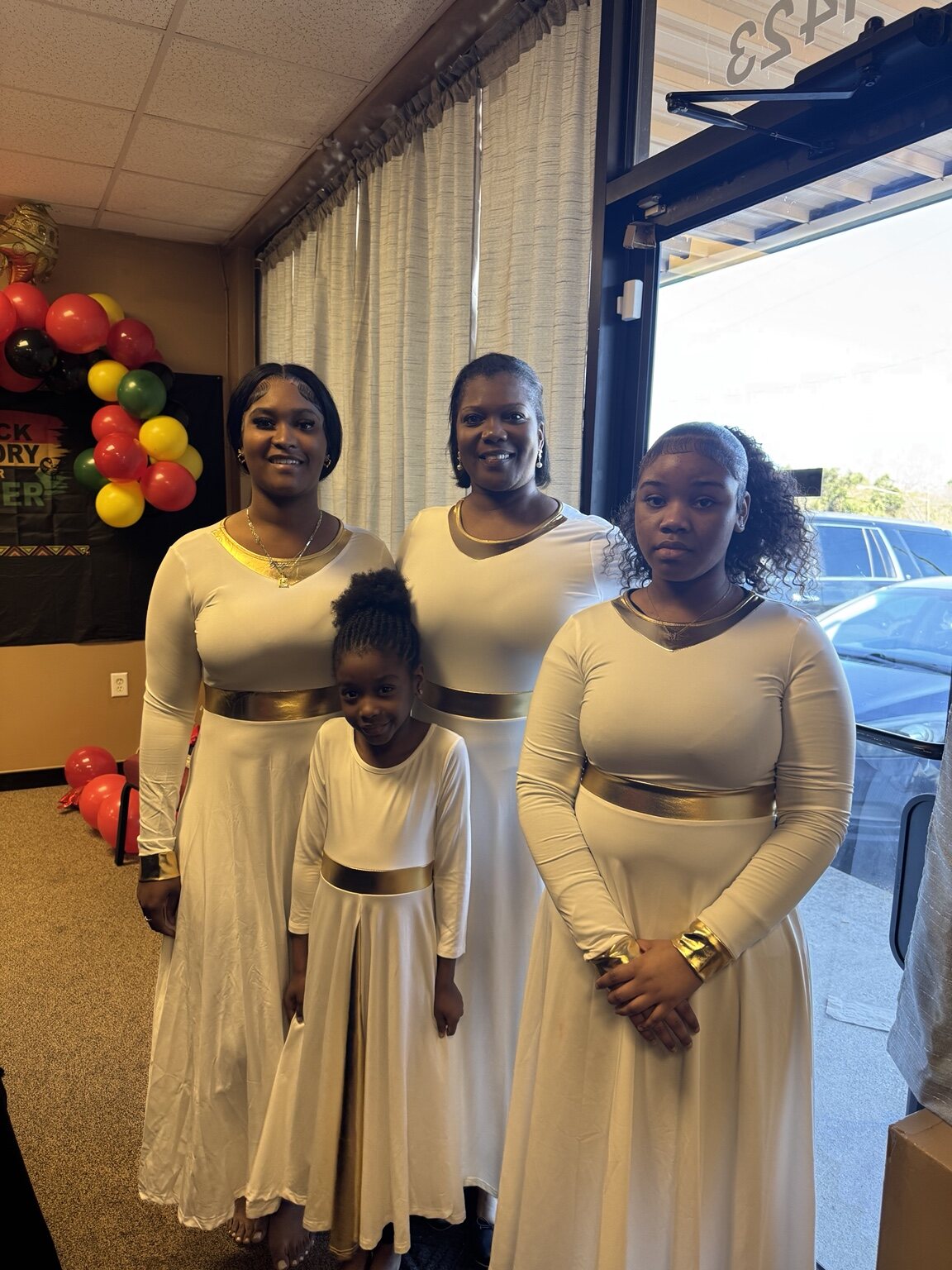 Youth and adult praise dancers dressed in white and gold