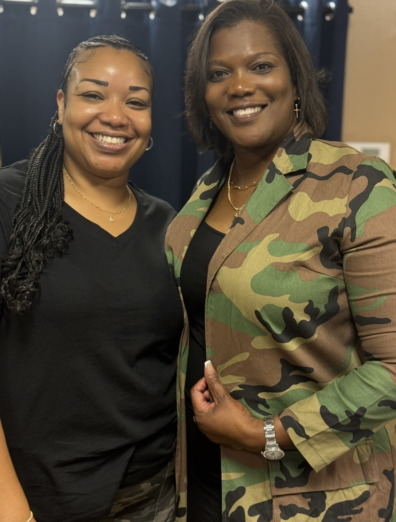 Two women smiling together during a ministry gathering